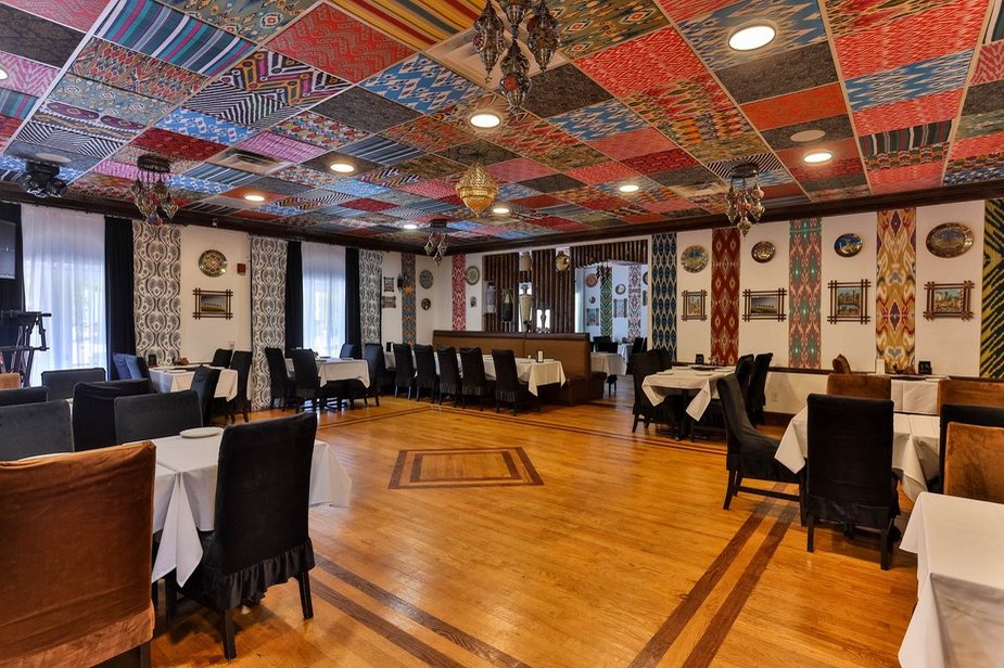 The main hall at Old Bukhara with ikat-covered ceiling panels and hardwood floors